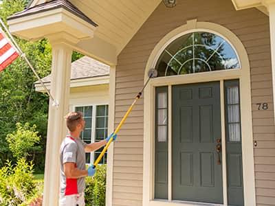 local maine pest control specialist knocking down cobwebs