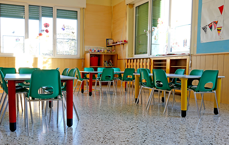 Ensure The Health Of Your Children interior of a daycare room without children filled with small tables and chairs