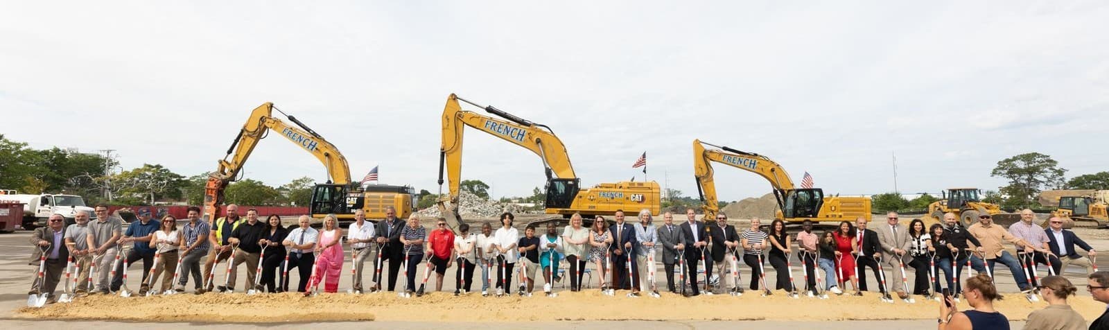 People Standing in front of Construction Equipment