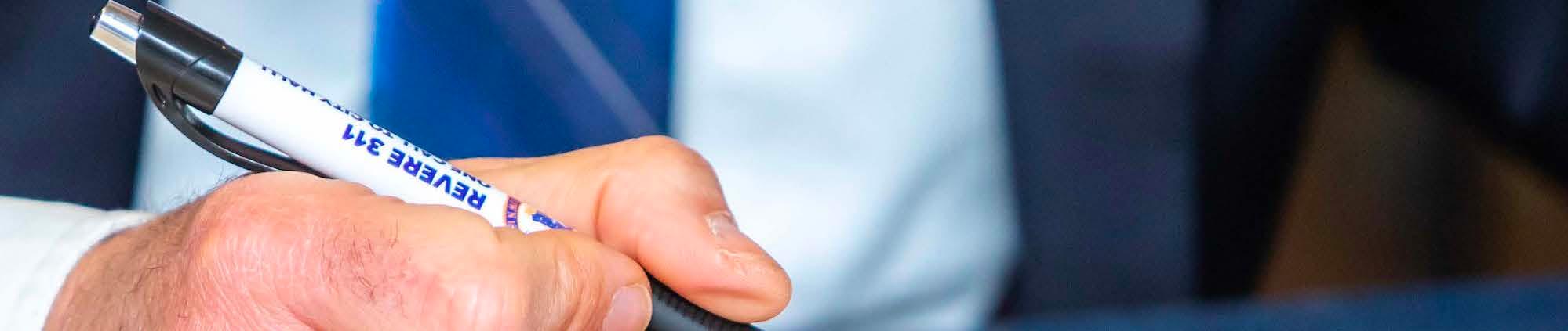 Person Holding a Pen