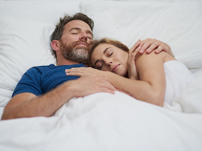 couple sleeping in a bed