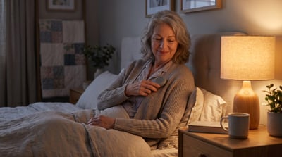 Woman using a handheld remote to start nerve stimulation therapy for sleep apnea