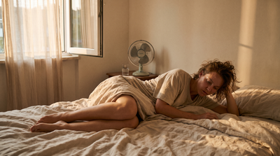 Person experiencing restless, sweaty sleep from summer heat, showing how rising temperatures worsen sleep apnea