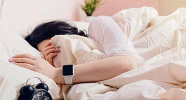 person wearing a smart watch while sleeping