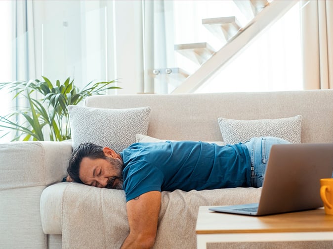 tired man sleeping on the couch