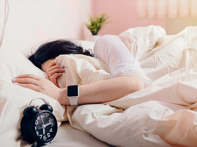person wearing a smart watch while sleeping