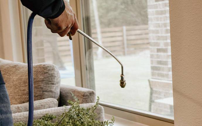 Our Treatments Are Thorough And Guaranteed pest control technician treating a yard