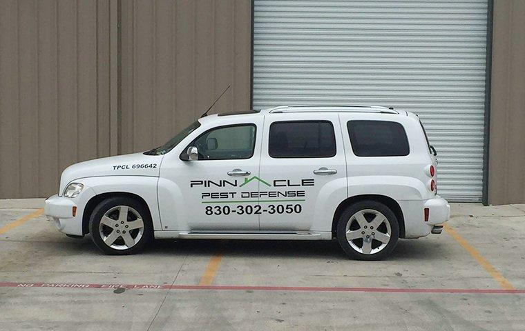 pinnacle pest defense vehicle near a commercial building