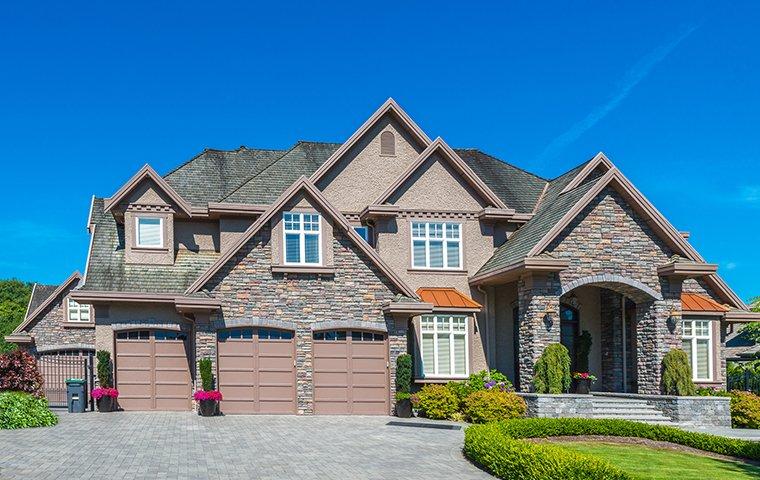 a three story house with attached garage