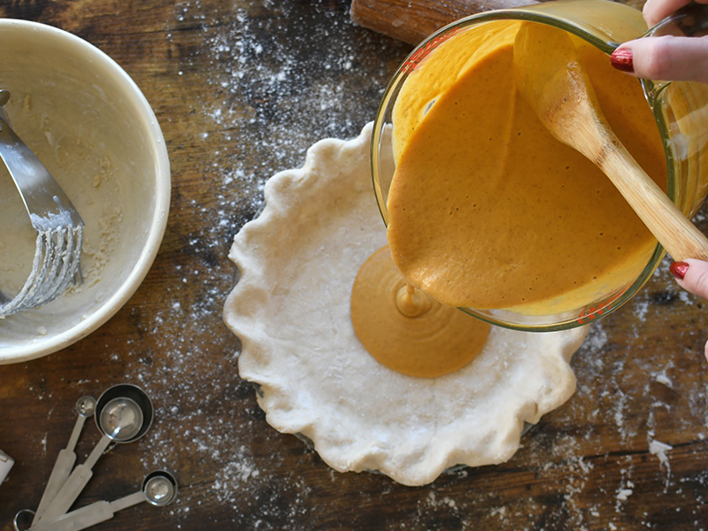 a person making pumpkin pie