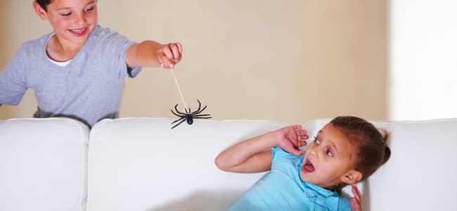 Six Best Pest Freak Outs child scaring another child with fake spider