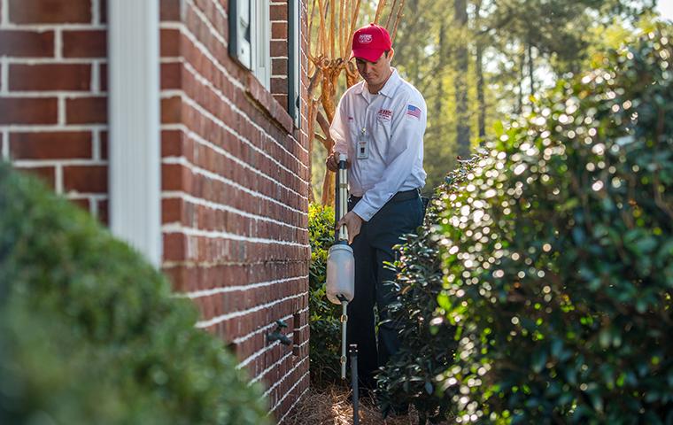 aiken tech treating for pests outside a house in south carolina