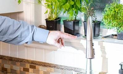 tech inspecting a kitchen sink