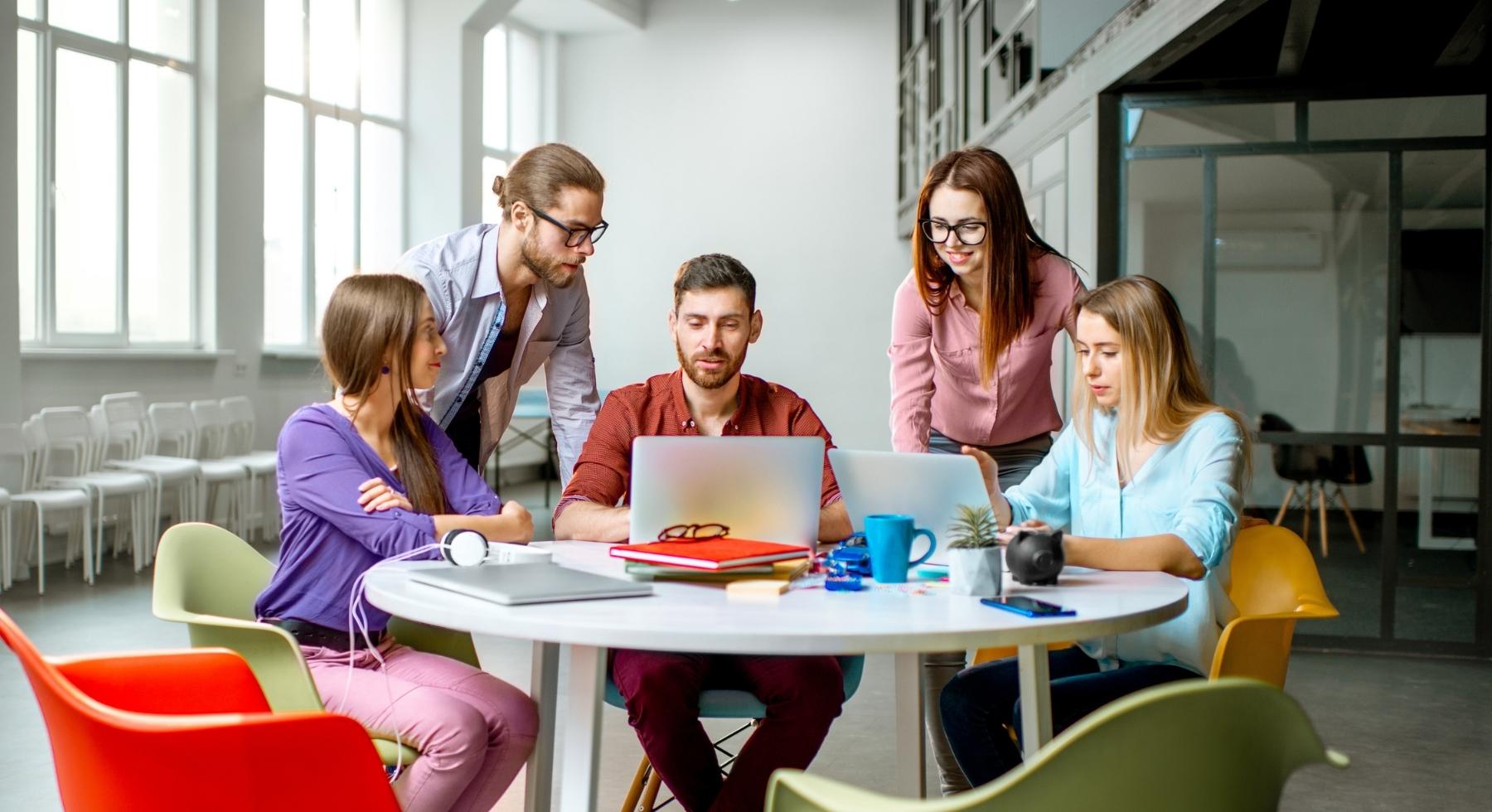 Group of young professionals sitting around a table