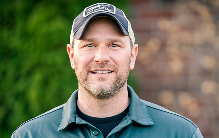 Eco Pest Control Is Family Owned And Operated an eco pest control service technician outside of a home in port huron michigan