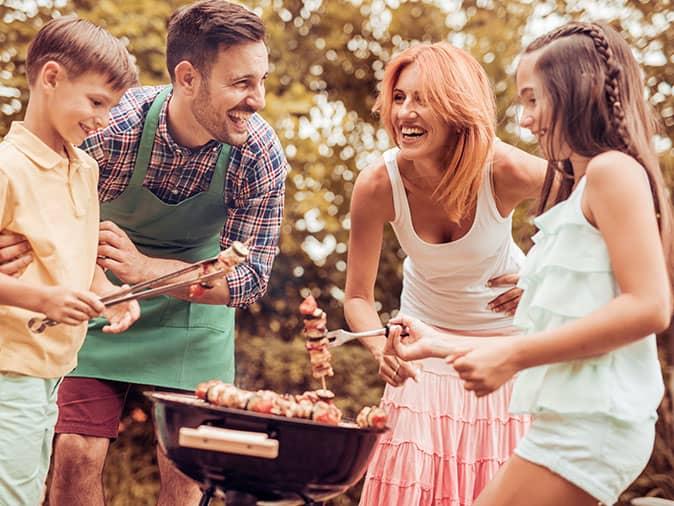 Learn More About Preventing Pests Around Your New Jersey Home This Summer happy family outside a brick nj home protected from mosquitoes and ticks