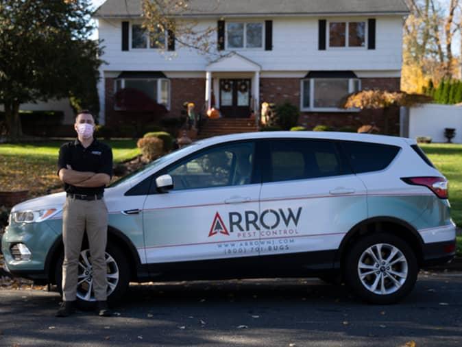 Learn More About Protecting Your Home From Pests During The New Jersey Holiday Season professional pest control tech outside of a protected home