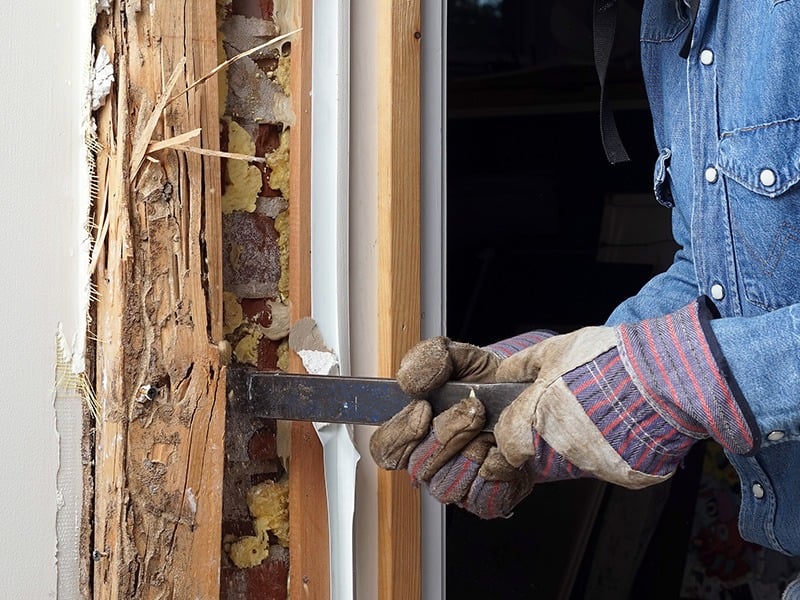 contractor tearing out door frame