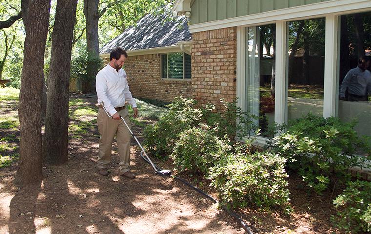 a pest tech treating highland park texas home for termites