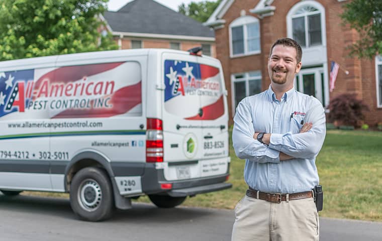 High Quality Pest Control In Gallatin TN technician standing in front of his vehicle outside of gallatin tennessee home