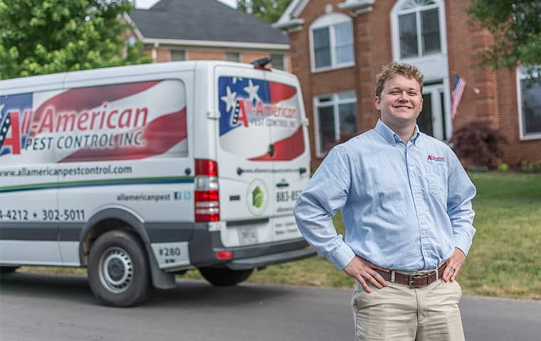 Learn More About Home Pest Control In Thompsons Station TN all american tech standing in front of service vehicle outside of clients home in thompsons station tennessee