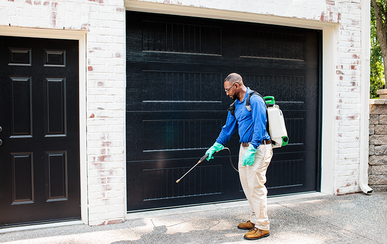Thorough & Proactive Pest Control Solutions pest control technician treating a brentwood tn home
