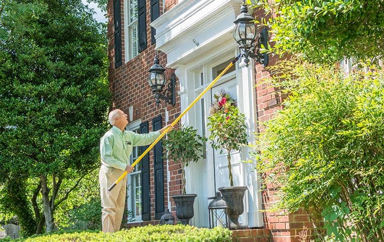 Eco-Friendly, Responsible Pest Control nashville pest control technician performing cobweb removal